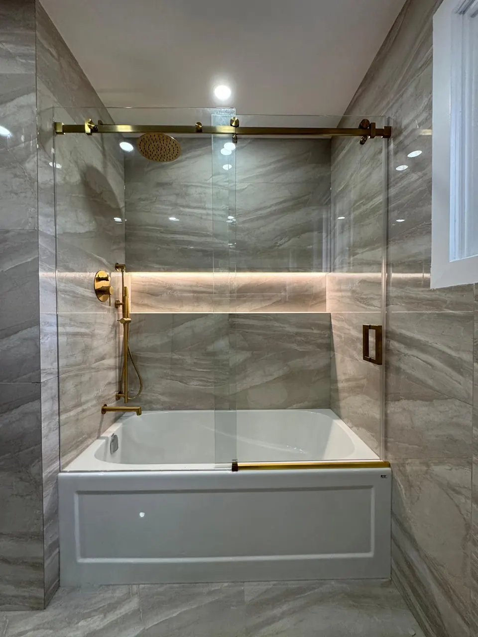 Tub and shower combination with gold sliding glass door